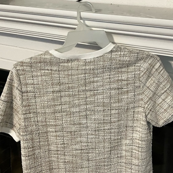 Short sleeved top with a woven style pattern in black, tan, white. - Picture 2 of 5
